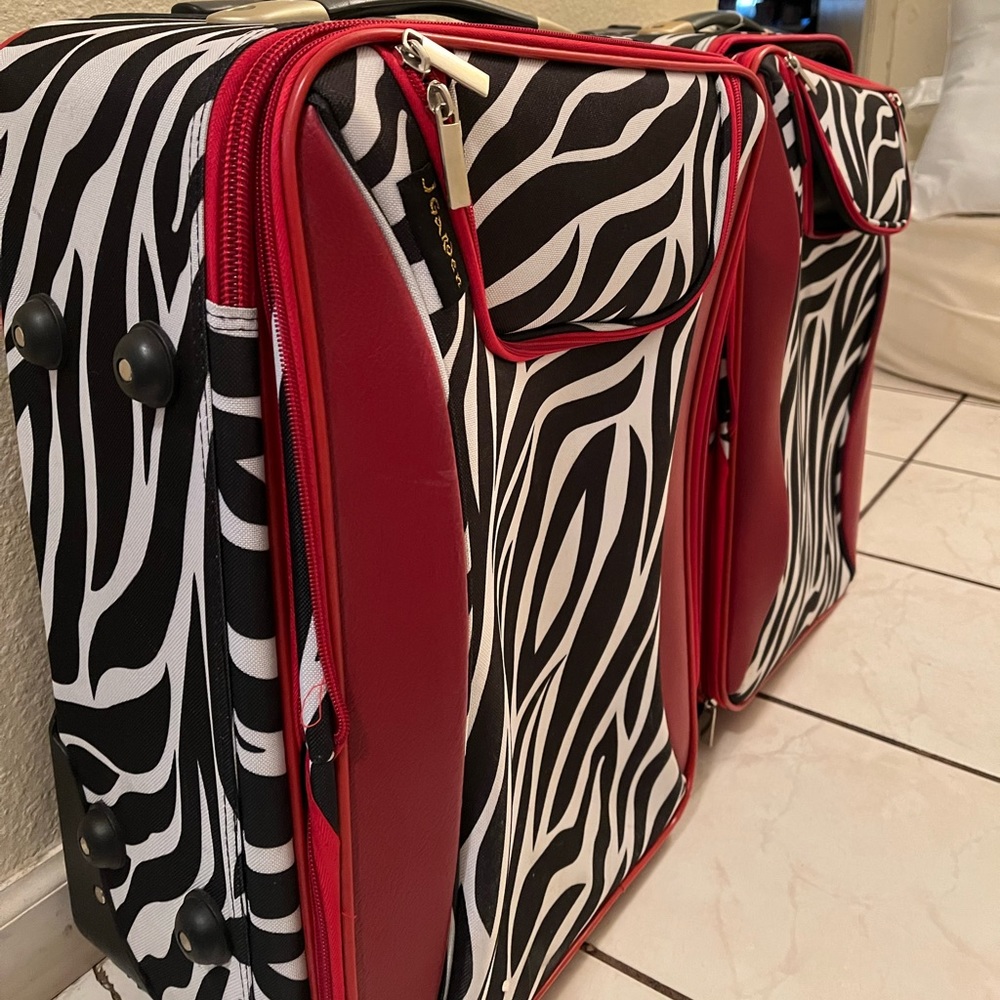 Red and zebra pattern stationary suitcases